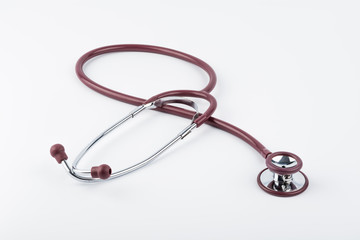 Red stethoscope medical equipment on white background