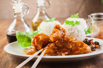 Chicken pieces with rice and sweet and sour sauce