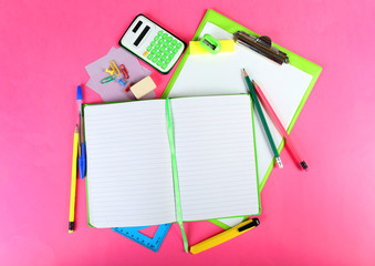 Office and student tools on pink background closeup