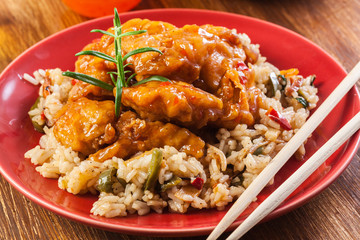 Chicken pieces with rice and sweet and sour sauce