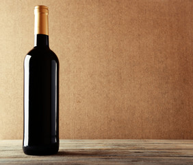 Bottle of red wine on wooden table