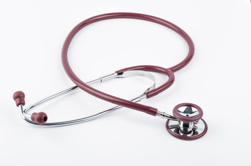 Red stethoscope medical equipment on white background