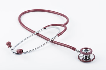 Red stethoscope medical equipment on white background