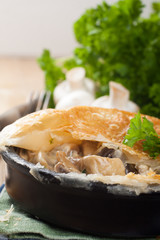 Stewed mushrooms under puff pastry.