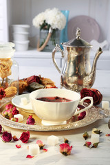 Hot rose tea on metal tray