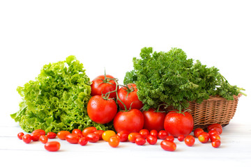 Fresh tomatoes and different herbs in a wicker basket.