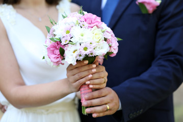 Bride and groom holding wedding bouquet