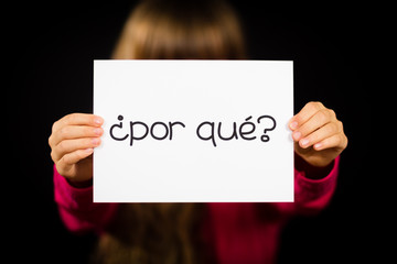Fototapeta premium Child holding sign with Spanish words Por Que - Why