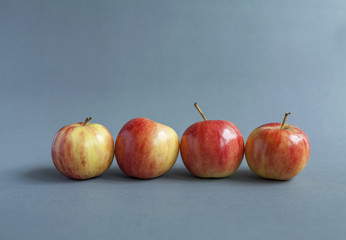 Mini fresh red apple on grey background