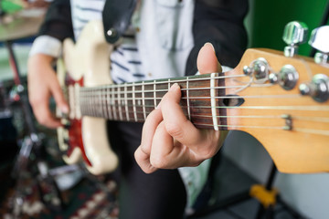 Fototapeta na wymiar Midsection Closeup Of Woman Playing Guitar