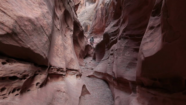 Friends hiking narrow desert mountain slot canyon HD 1599