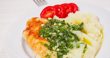 Roasted chicken breast with pesto sauce and mashed potatoes