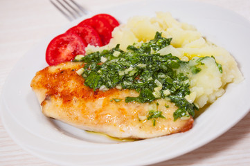 Roasted chicken breast with pesto sauce and mashed potatoes
