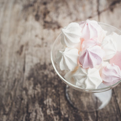 pink and white meringue cookies, top view, selective focus