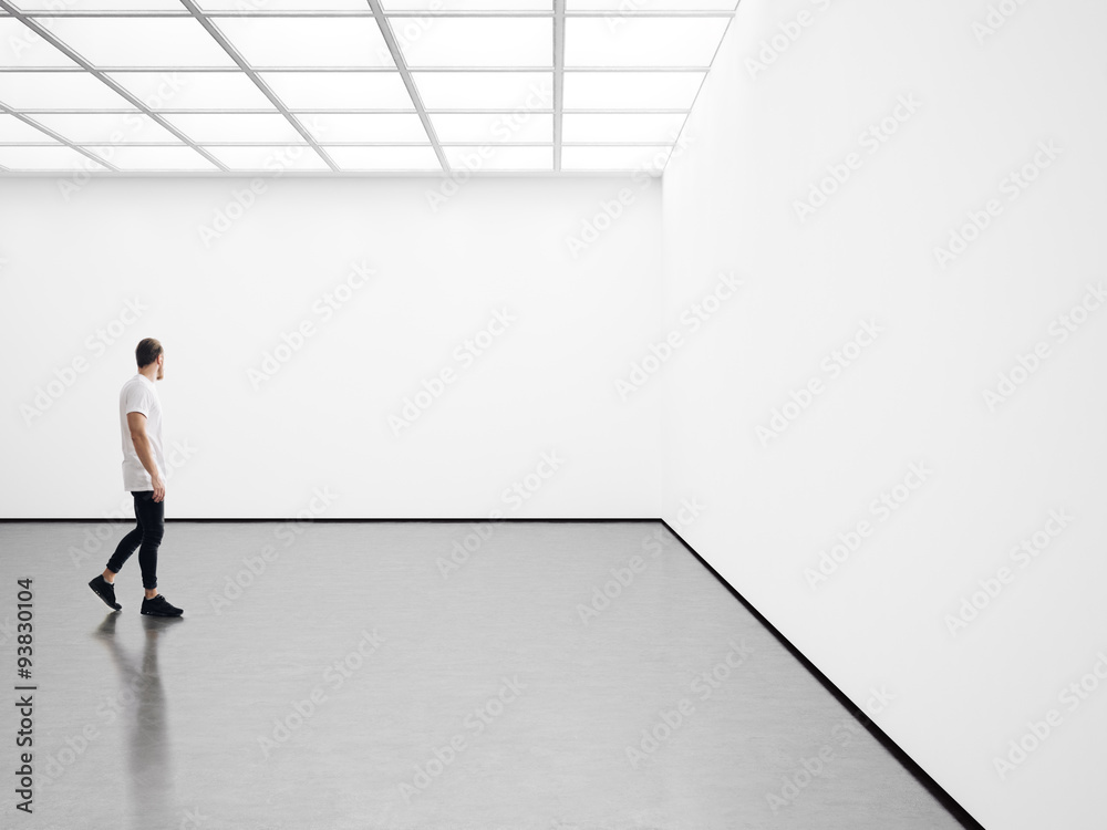 Wall mural white interior with white canvas and young man.