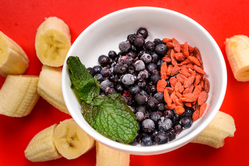 Ingredients for fruit smoothies with banana, blueberries, goji berries and mint