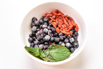 Ingredients for fruit smoothies with banana, blueberries, goji berries and mint