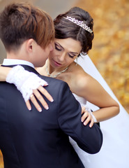 Bride and groom are walking in autumn forest 