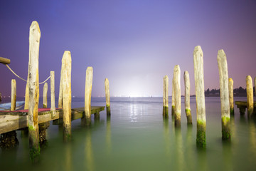 poles in the lagoon of Venice by night