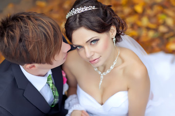 Bride and groom are walking in autumn forest 