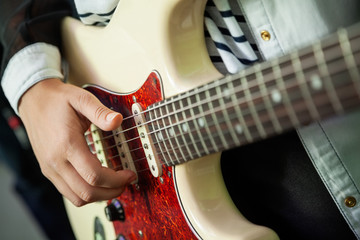 Fototapeta premium Woman's Hands Playing Guitar In Recording Studio