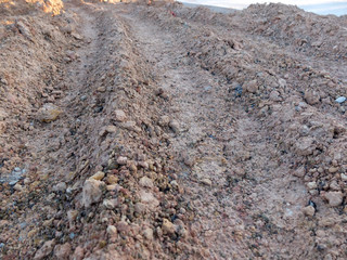 Wheel track in laterite soil excavation site, construction textu