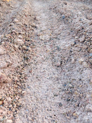 Wheel track in laterite soil excavation site, construction textu
