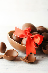 Chocolate Easter eggs on white wooden background