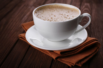 Cup of coffee on brown napkin closeup