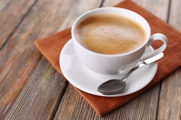 Cup of coffee on brown napkin closeup