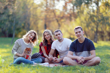 group of young people in the autumn picnic