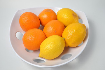 lemons and oranges on a plate