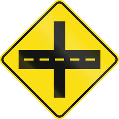 Obraz premium Warning road sign in Quebec, Canada - Crossing with primary road ahead