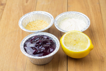 blue berry cheese pie tart and cut lemon on wood background