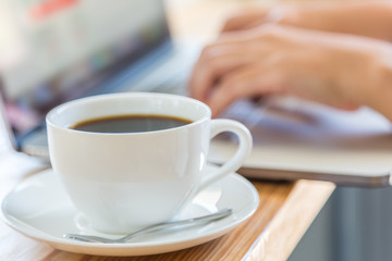 Coffee cup  with laptop on old wooden table