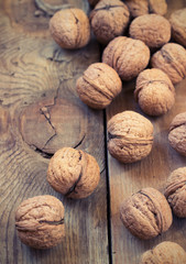 Pile of walnuts  on a wooden background