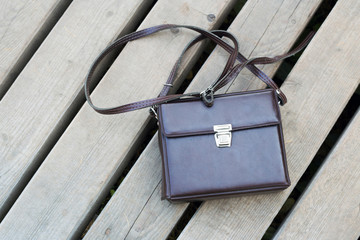 Brown briefcase at wooden background