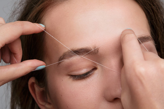Eyebrow correction with a white thread
