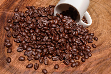 Coffee beans on the wooden background.