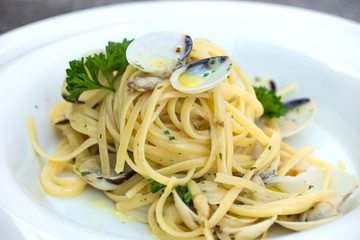 Spaghetti alla vongole on a wooden background 