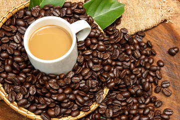 Coffee beans on the wooden background.