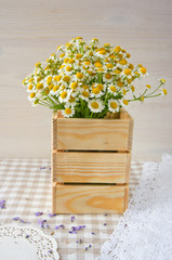 Bouquet of daisies on a vintage wooden surface