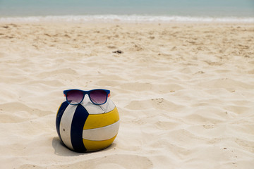 Obraz premium a Volleyball at the Summer Beach with a Sunglass