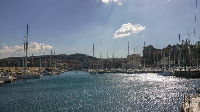 Time lapse of a sea port and a small town in a shiny day