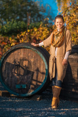 Full length portrait of woman standing in autumn vineyard