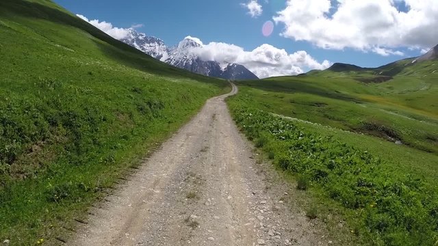Motorcycle riding on Zagar Pass dirt road high up in the Caucasus Mountains in Georgia