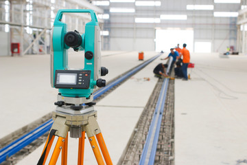 survey camera foreground with workers