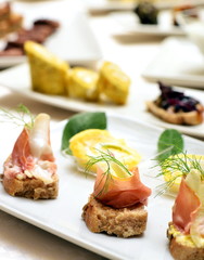 Tapas on Crusty Bread - Selection of Spanish tapas served on a sliced baguette.