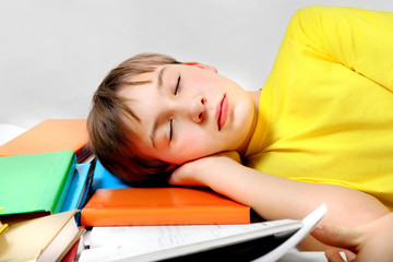Tired Kid sleep on the Books