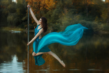 Girl flying dance, and her dress developing the wind.